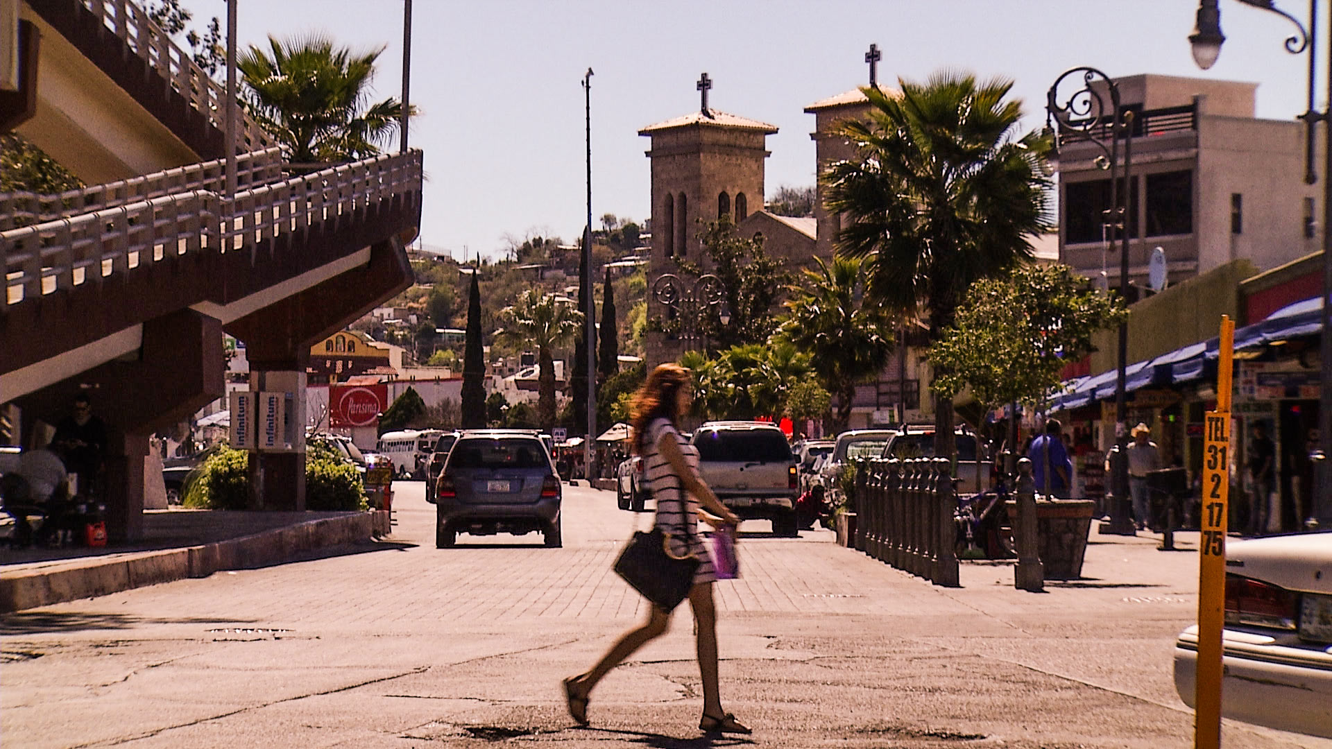 A woman crosses the street in Nogales, Sonora.