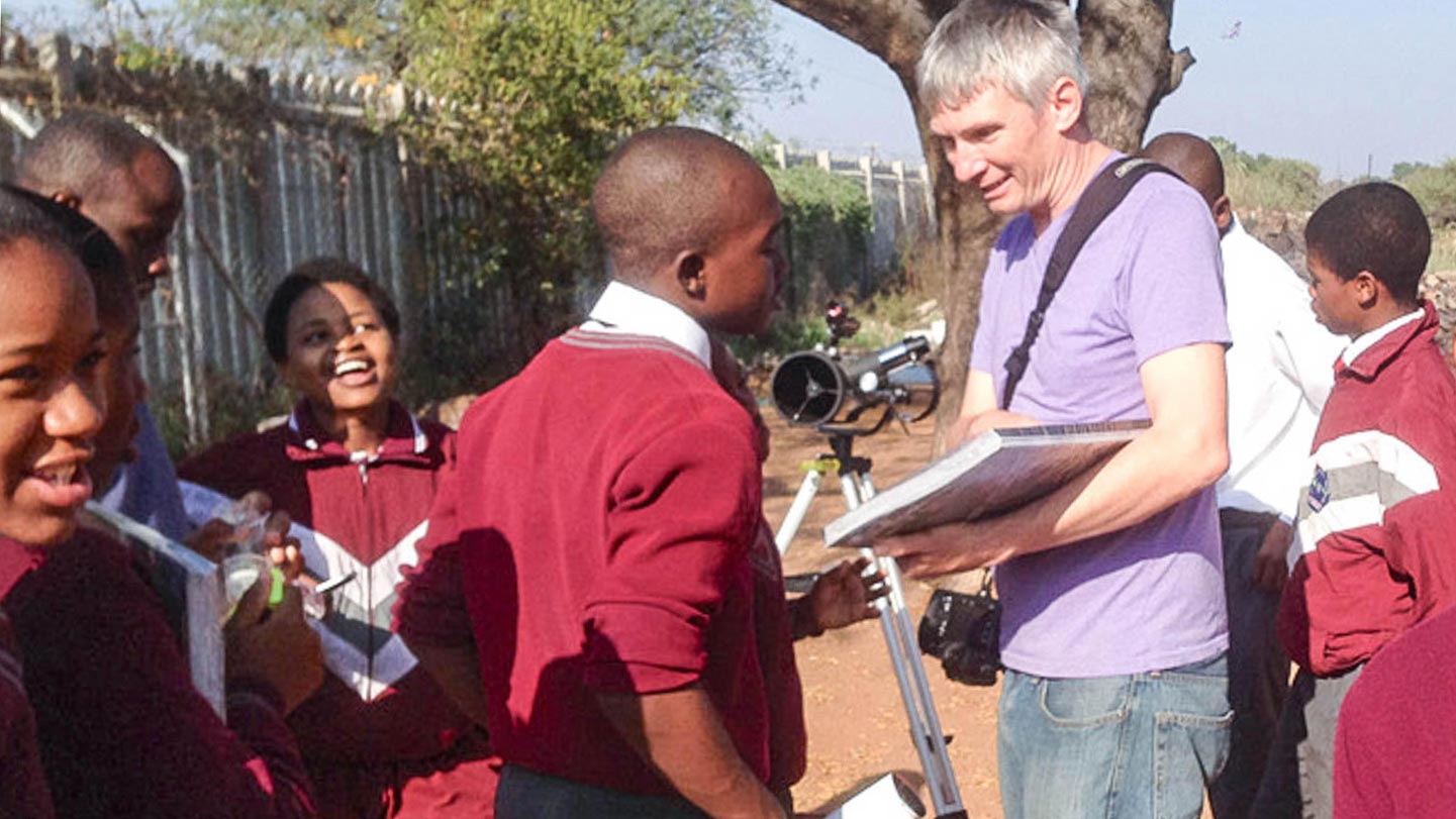 Henry Throop shows students how to use a telescope to observe sunspots during the day, at Dendron Secondary school in rural Limpopo, South Africa. 