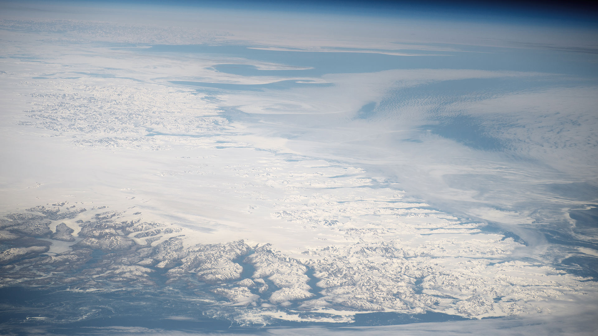 An aerial photo of the southern tip of Greenland's ice sheet, surrounded by glacier-carved fjords. UA scientist Jack Reeves Eyre says the island's ice melt could significantly raise sea levels in the next 50 years.