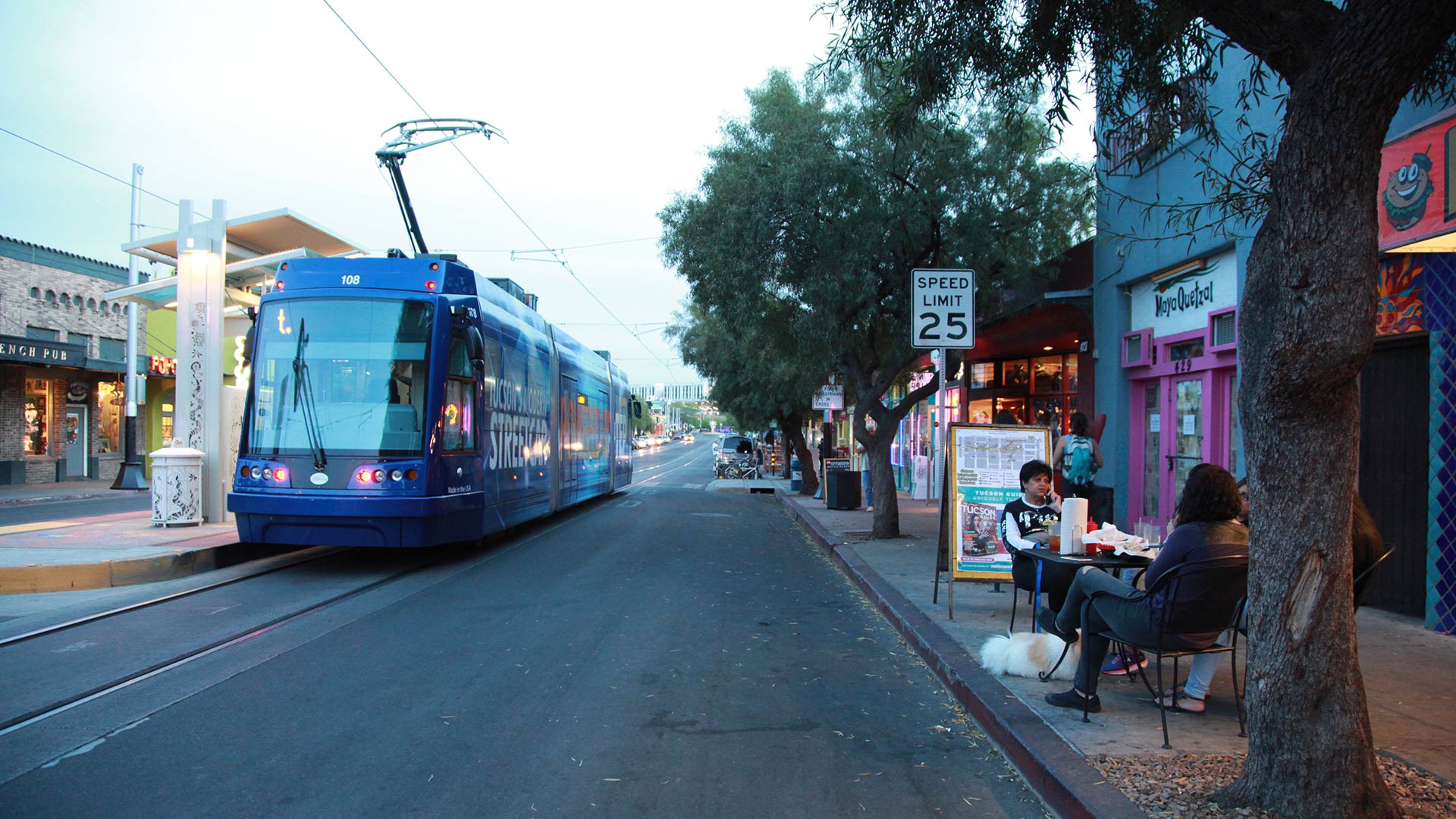 The streetcar passes people eating dinner on 4th Avenue on April 5, 2015. 