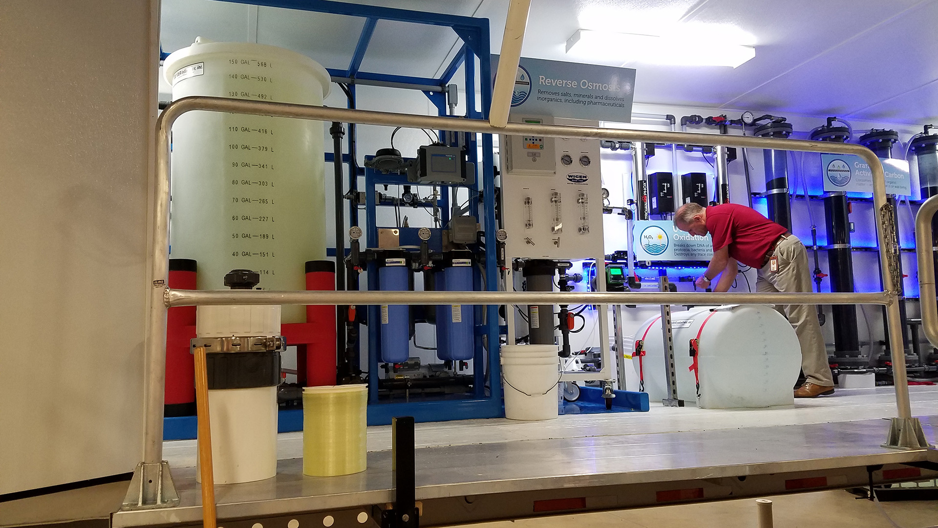 Pima County Wastewater Reclamation Department Research and Innovation Manager Jeff Prevatt examines water after it has come through the county's new water purification truck.