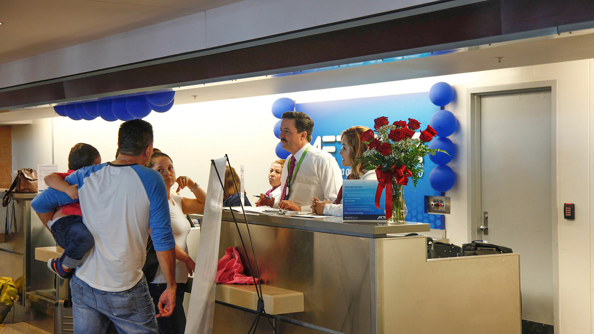 Customers check in at the ticket counter on the first day of Aeromar's 10-month service to and from Tucson.