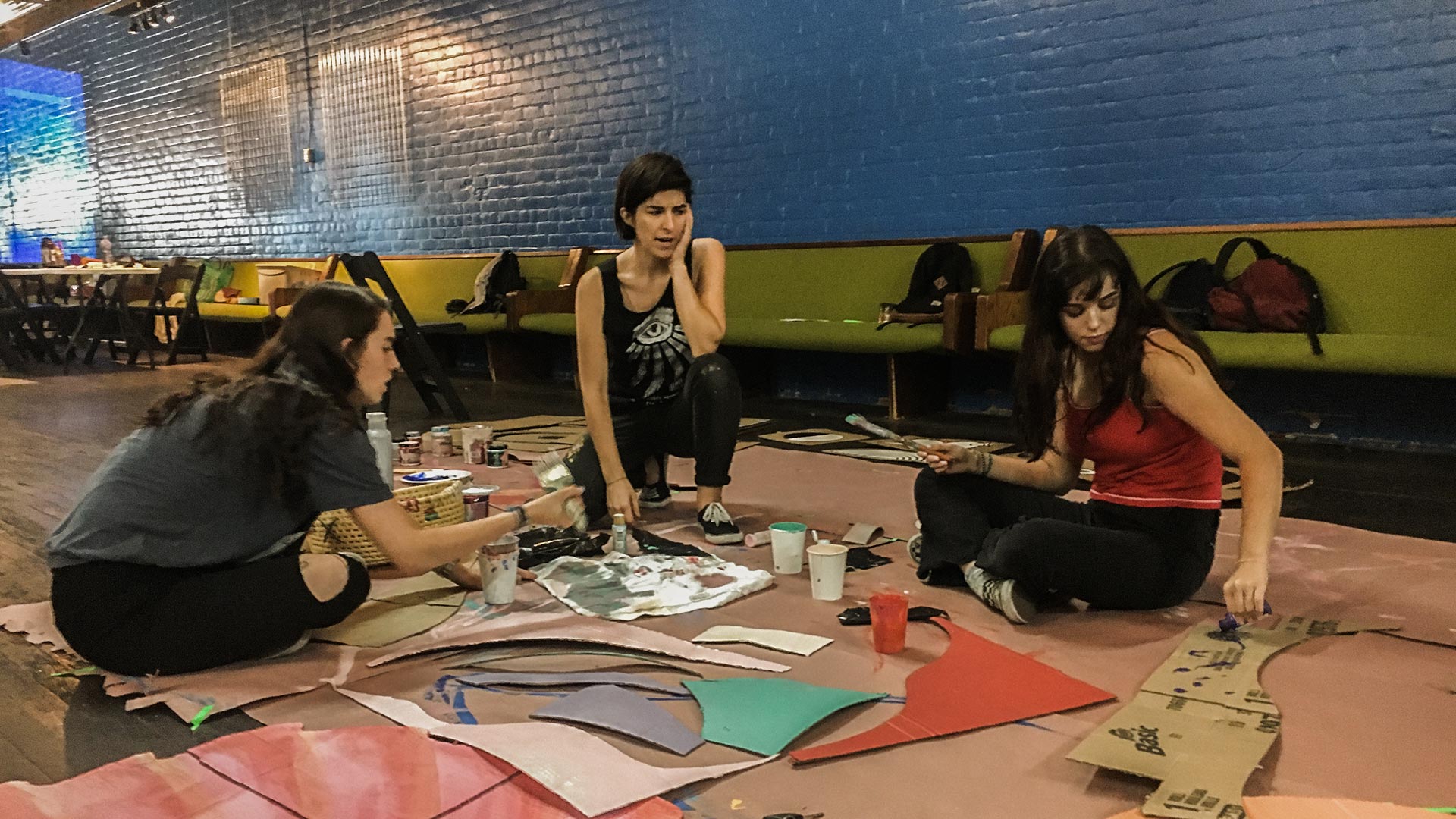 Lano Dash assembles an art installation with her little sister, Sophia, and her friend, Renae. The piece will be featured at this year's Chick Magnet festival. 