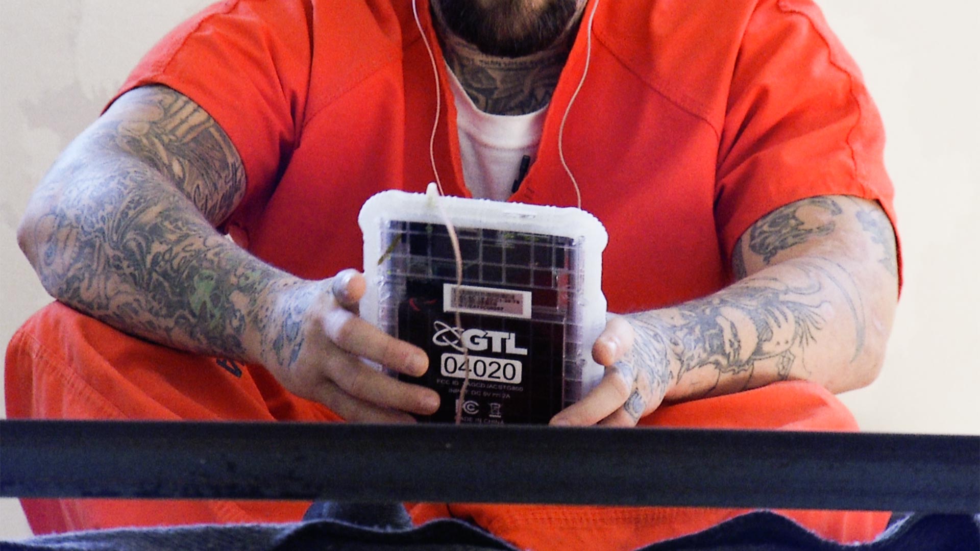 An inmate at the Pima County Jail uses a tablet.