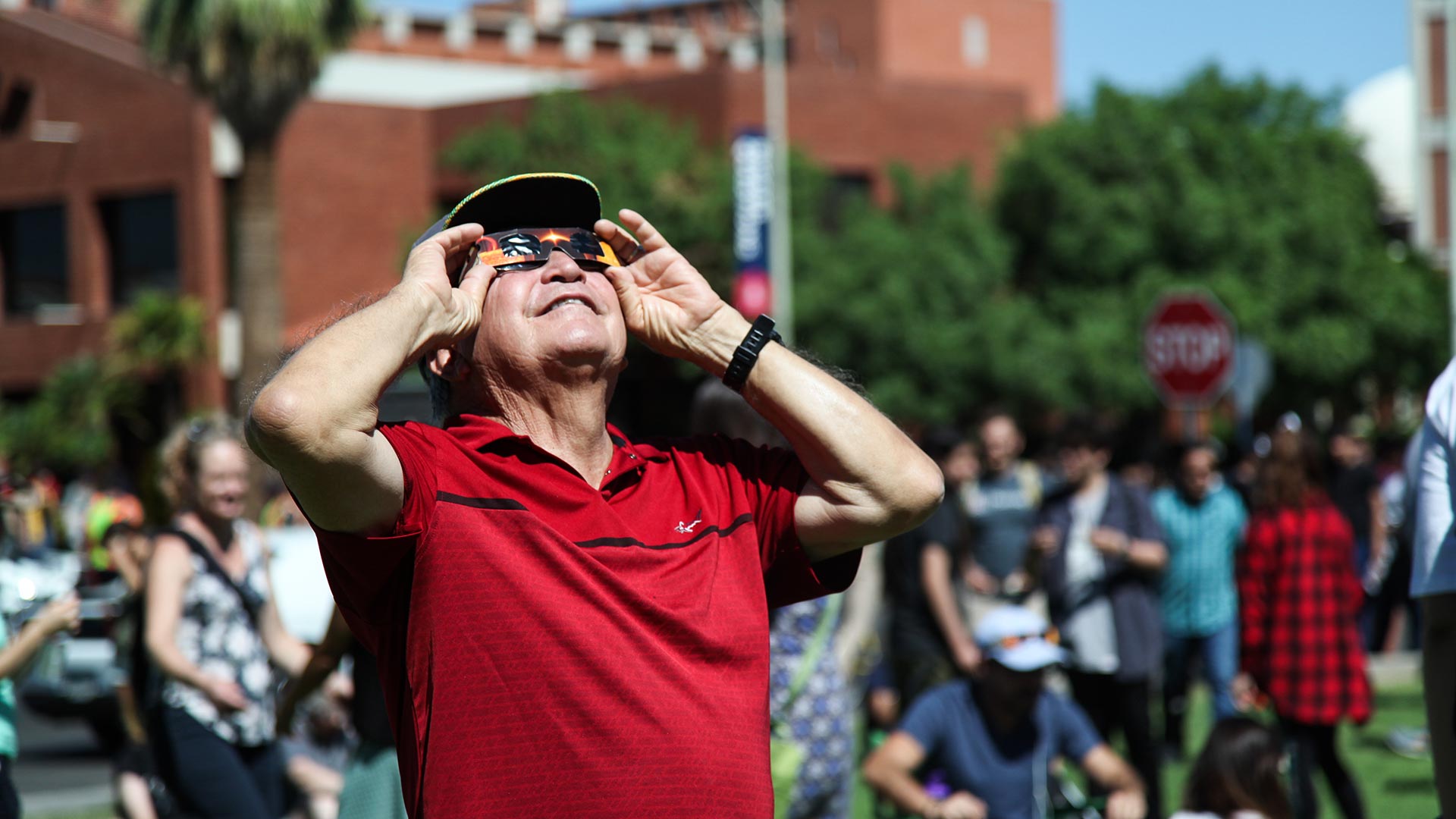 Tucsonan Rafael Guillen views the solar eclipse through glasses he purchased at the UA's Flandreau Science Center and Planetarium. 