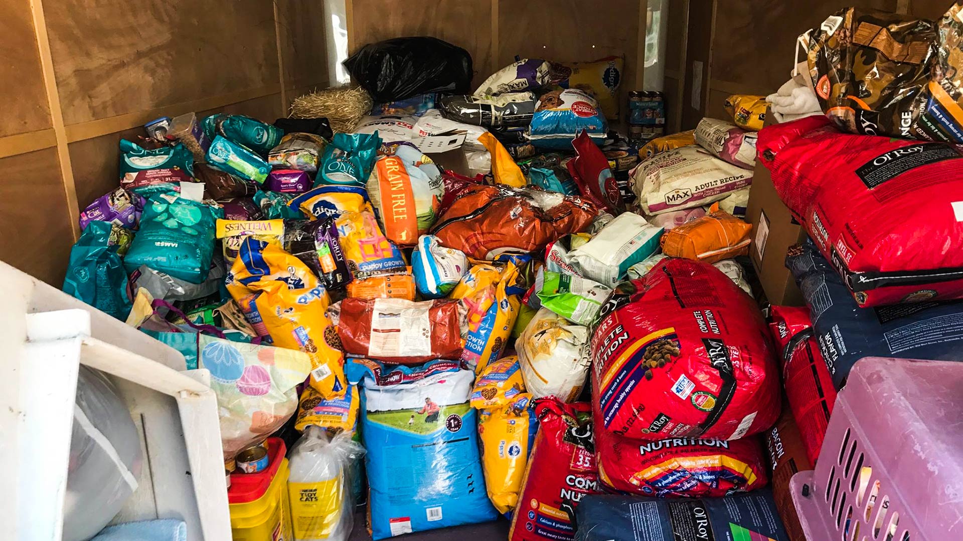 Thousands of pounds of food and pet supplies being loaded on trailers for the 14-hour drive from Tucson to South Texas.