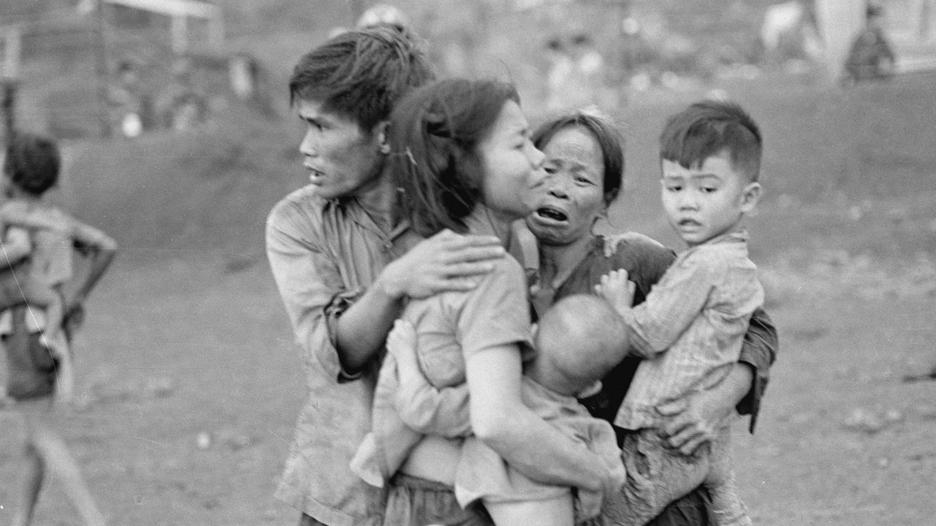 Civilians huddle together after an attack by South Vietnamese forces. Dong Xoai, June 1965.