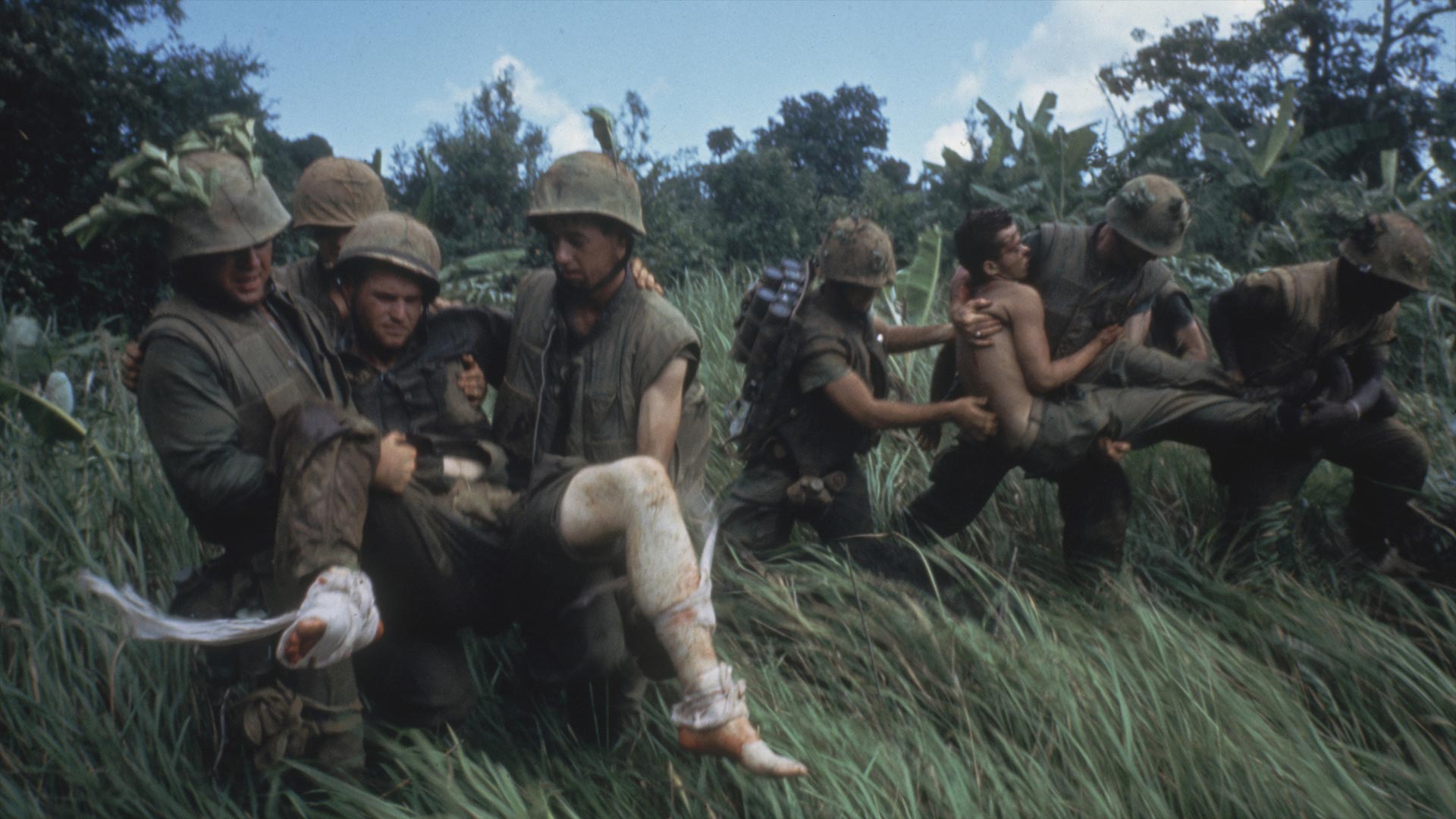 Marines carrying their wounded during firefight near the DMZ. 1966.