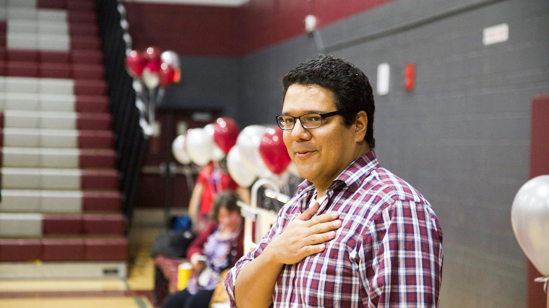 Desert View High School chemistry teacher Jonathan Cadena breathes out following the surprise announcement that he was the recipient of a Milken Educator Award.