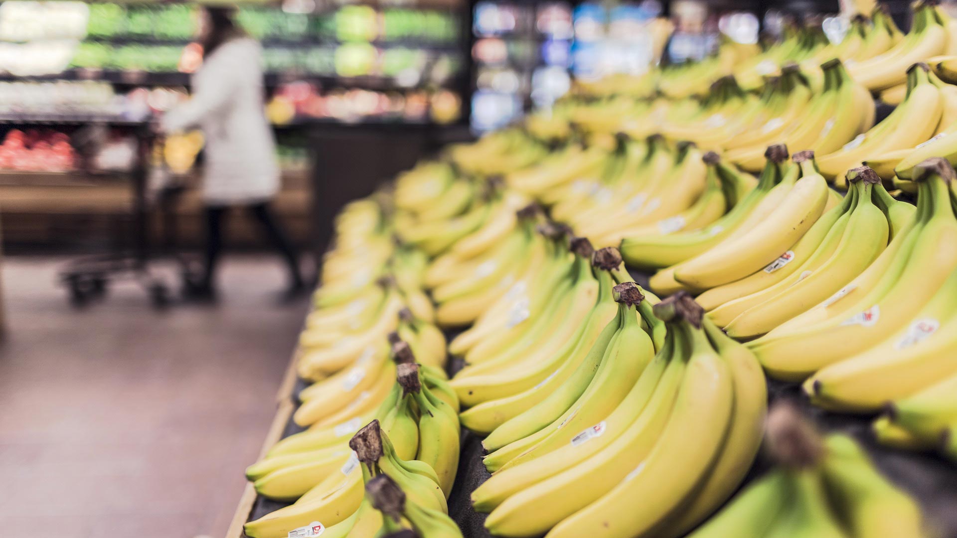 Bananas in the produce section of a grocery store.