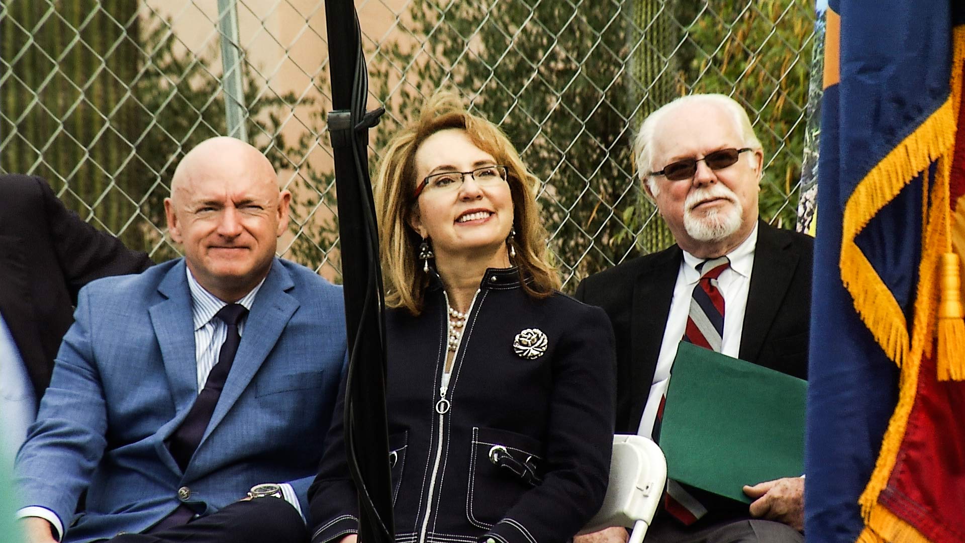 Mark Kelly, Gabrielle Giffords and Ron Barber at a memorial for the 2011 mass shooting in Tucson, Jan. 8, 2018.