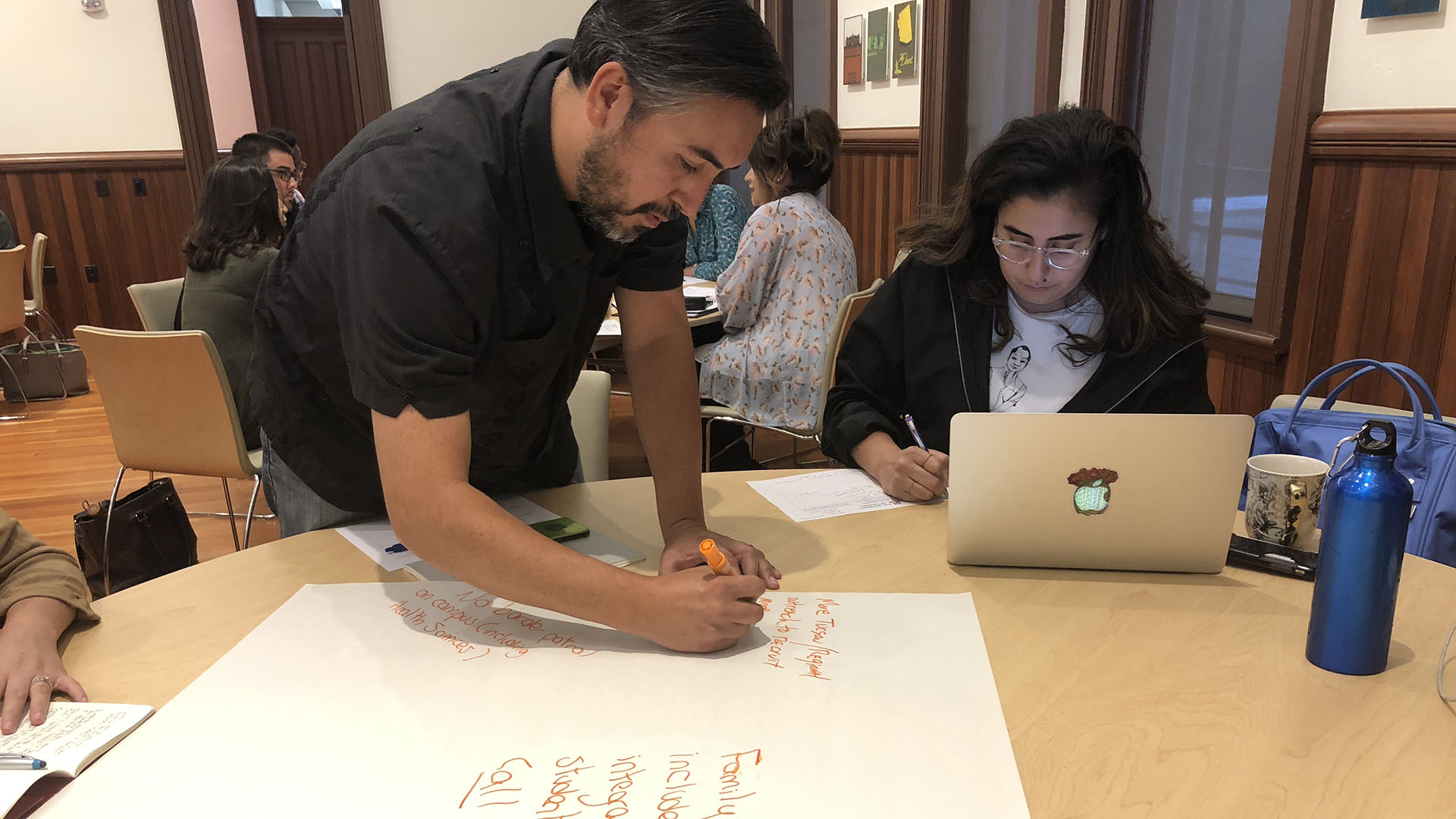 UA faculty member, Charlie Tousell (left), and Mexican American Studies Phd Student, Erika Nacim (right), sketch out their vision for the University of Arizona's Hispanic Serving Institution designation. 