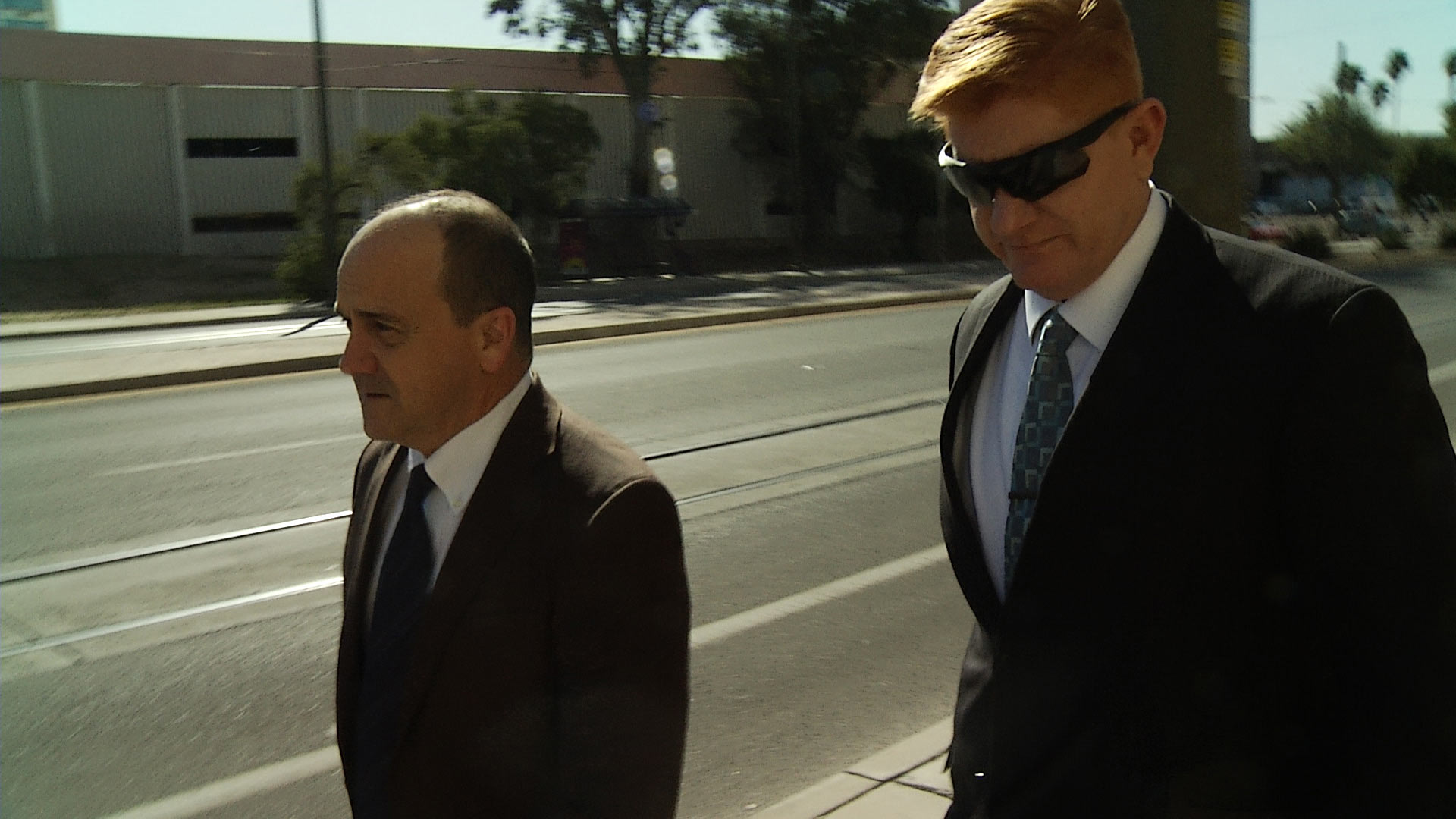 Border Patrol agent Lonnie Swartz, right, walks into federal courthouse with his attorney, April 2018.
