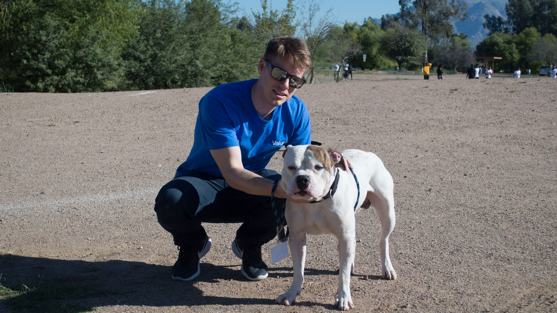 Alex Birch walks a dog at a Pima Animal Care Center volunteer event.