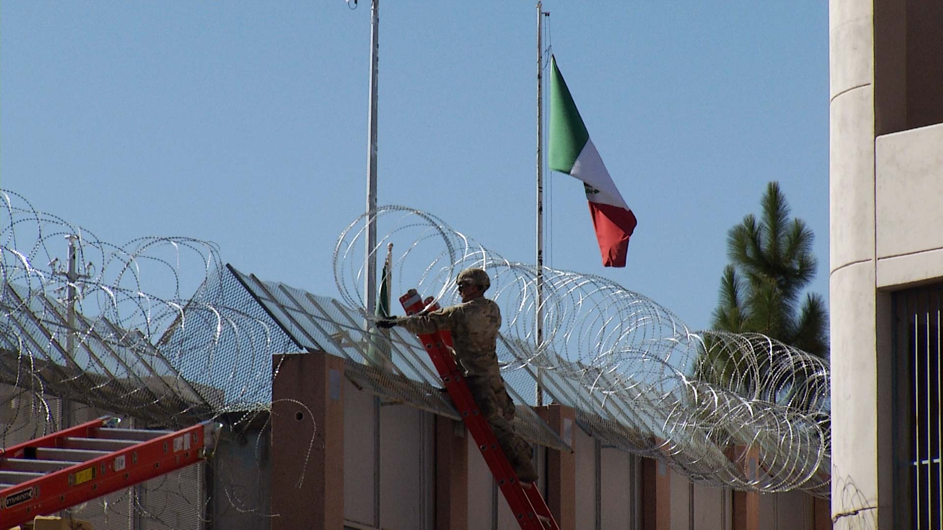 A soldier installs concertina wire along the border wall near the Dennis DeConcini Port of Entry in Nogales on Thursday, Nov. 15, 2018. The wire is meant to deter people from jumping the wall illegally, according to U.S. Customs and Border Protection.