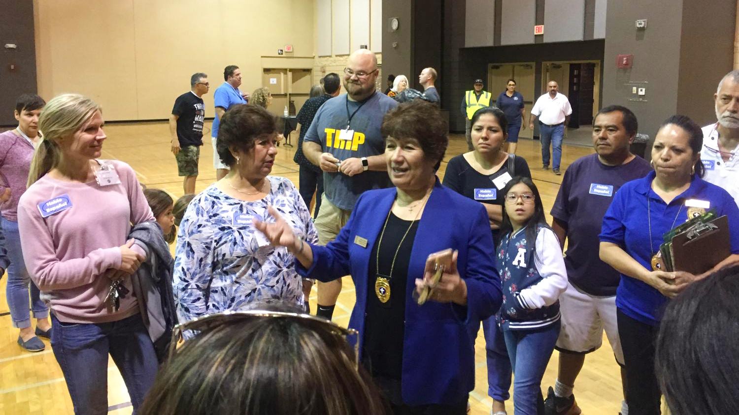 Rev. Magdalena Schwartz, center with blue jacket, briefs volunteers on Oct. 17 at Central Christian Church in Mesa before a large group of undocumented immigrant families and asylum seekers are dropped by federal authorities.
