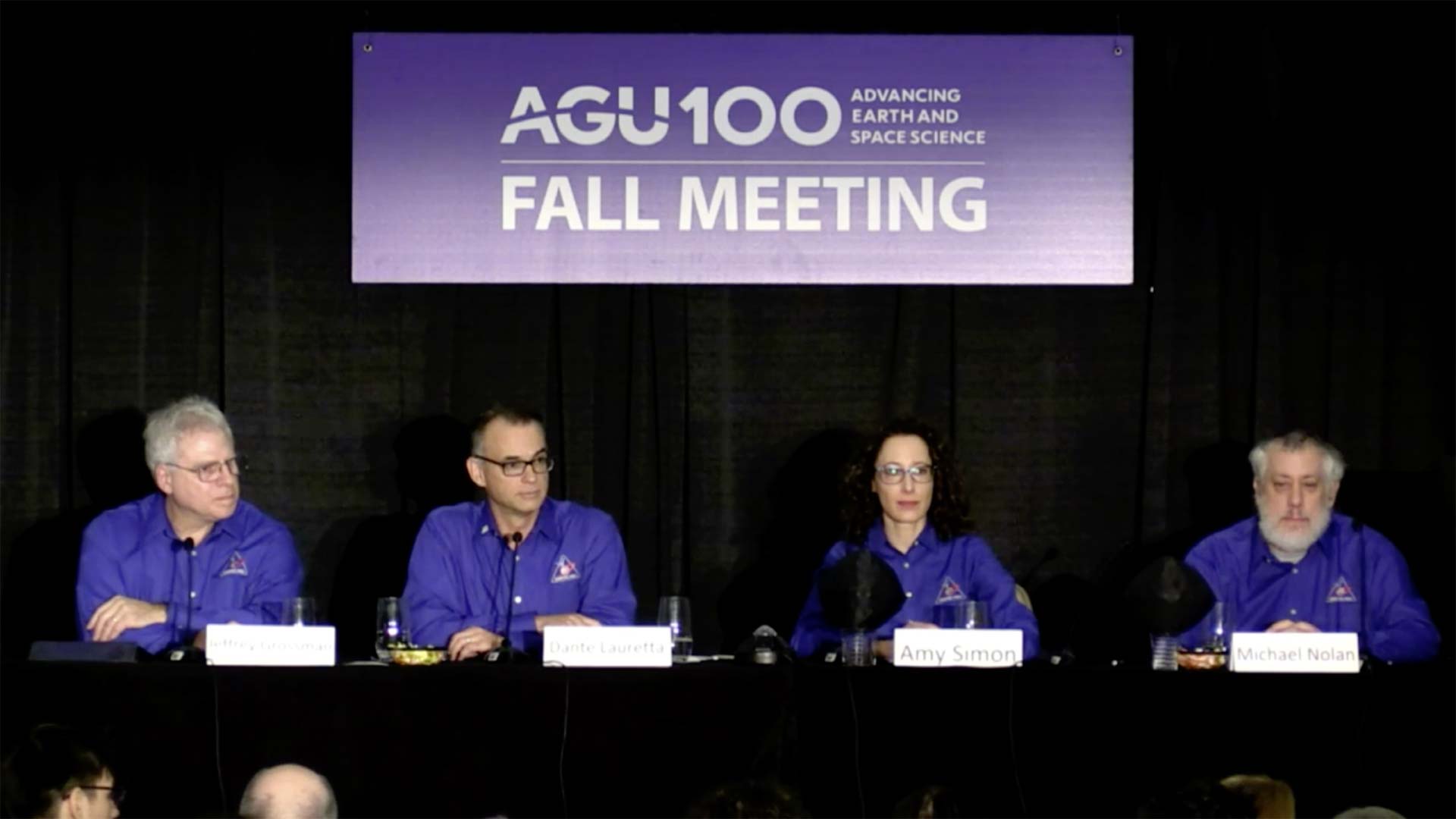 Scientists announce water findings in the clay of the asteroid Bennu in this still image from a livestream of the American Geophysical Union's 2018 Fall meeting.

From left, Jeffrey Grossman, OSIRIS-REx program scientist at NASA Headquarters; Dante Lauretta, OSIRIS-REx principal investigator at the University of Arizona; Amy Simon, OVIRS Deputy Instrument Scientist at NASA Goddard Space Flight Center; and Michael Nolan, OSIRIS-REx science team chief at the University of Arizona.