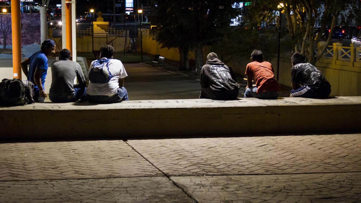 Honduran migrants hang out in a central plaza in Sonoyta, Mexico, across the border from Lukeville, Arizona.