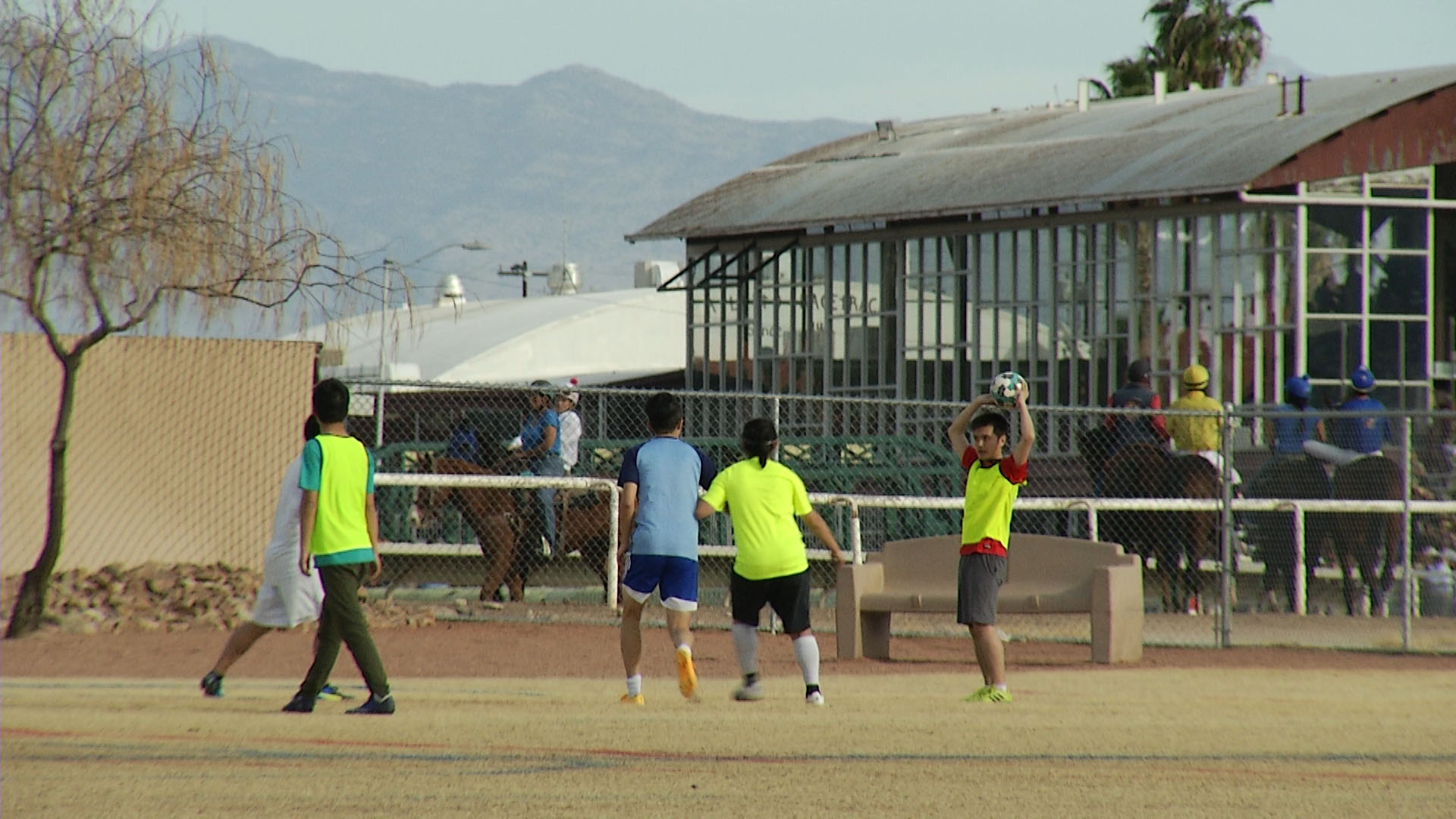 Soccer and horse racing co-exist at Rillito Park Racetrack.