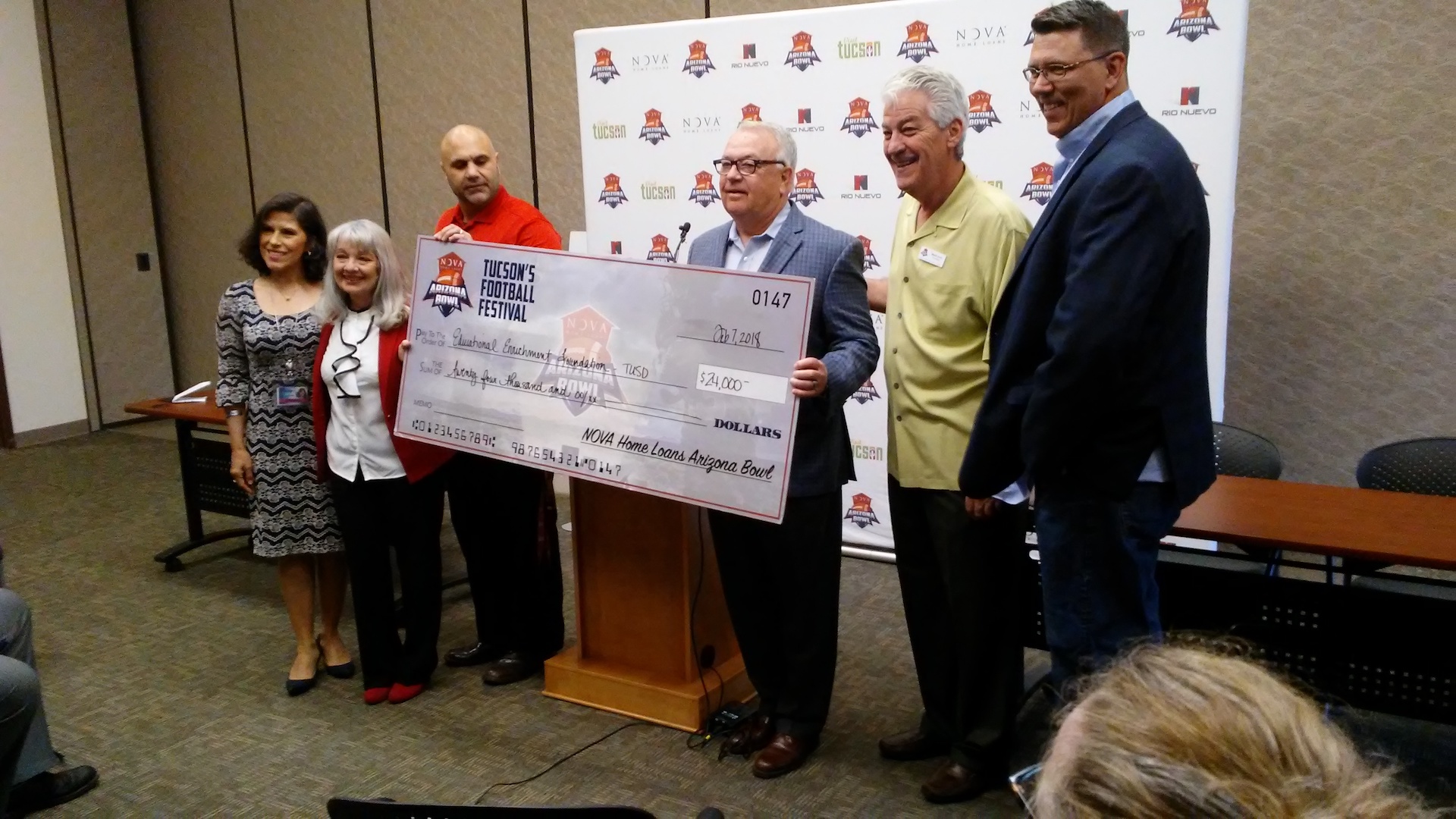 Arizona Bowl executive director Alan Young (third from right) delivers a donation to a Tucson teachers' foundation.  The money came from net proceeds gathered at the 2017 football bowl game.