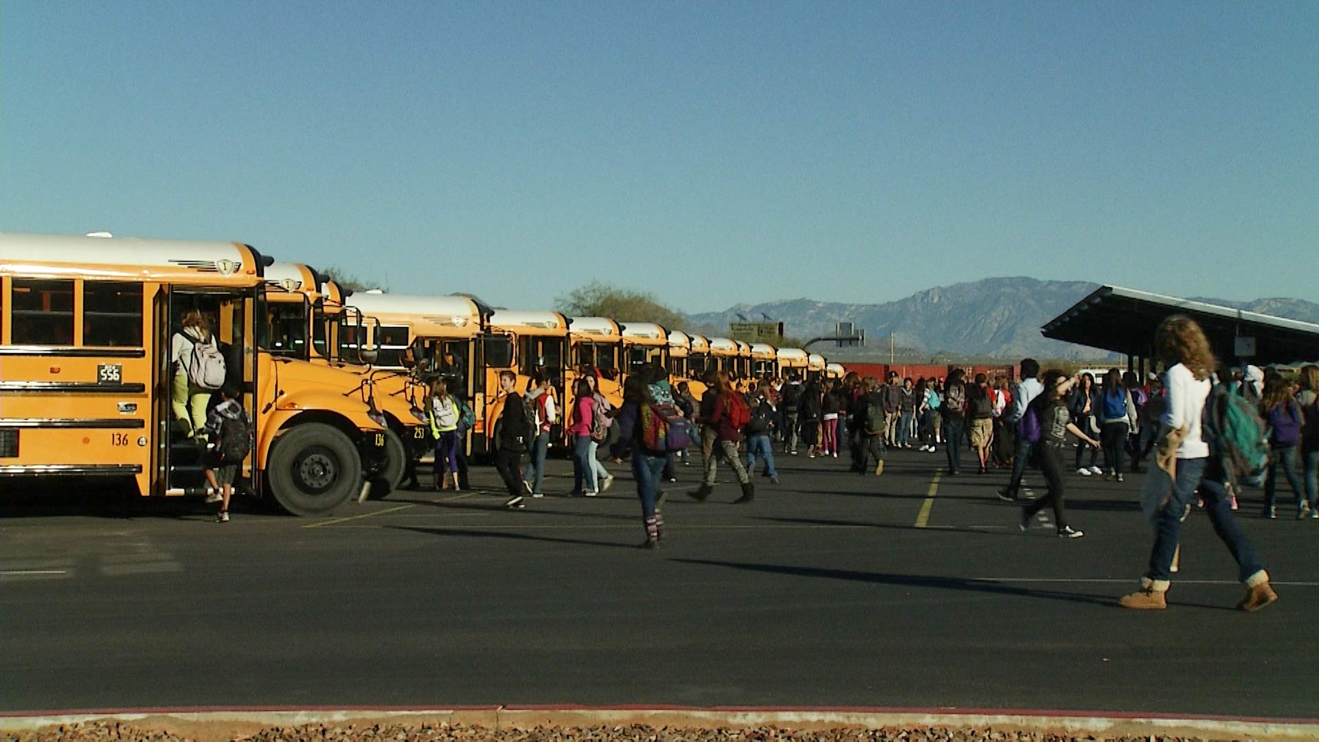 Tucson students head to buses after getting out of class.