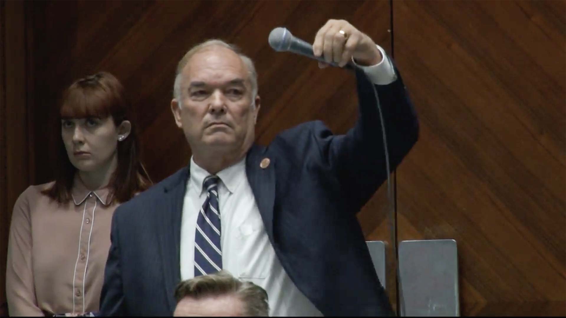 Don Shooter drops his microphone after speaking on the floor of the Arizona House prior to a vote to expel him, Feb. 1, 2018.