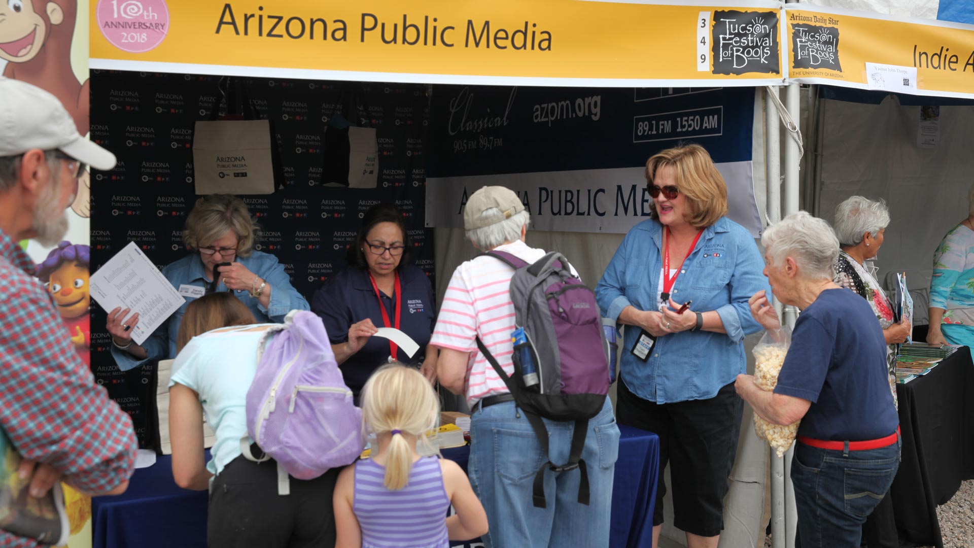 Sharing information with guests at the tent on the UA Mall.