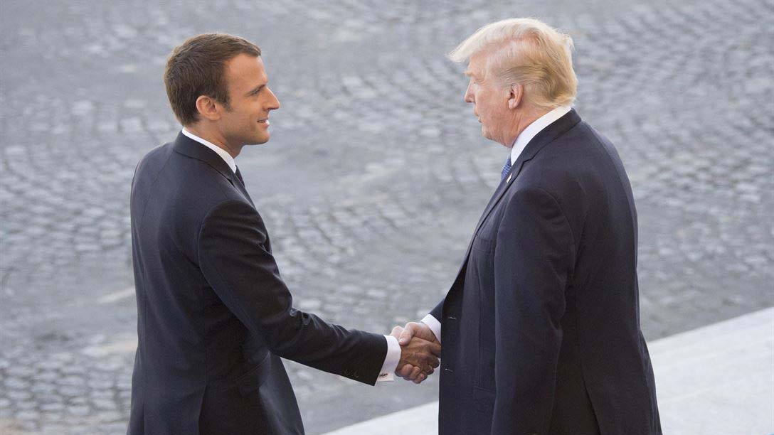 French President Emmanuel Macron welcomes President Donald J. Trump to the reviewing stand for the Bastille Day military parade in Paris, July 14, 2017.