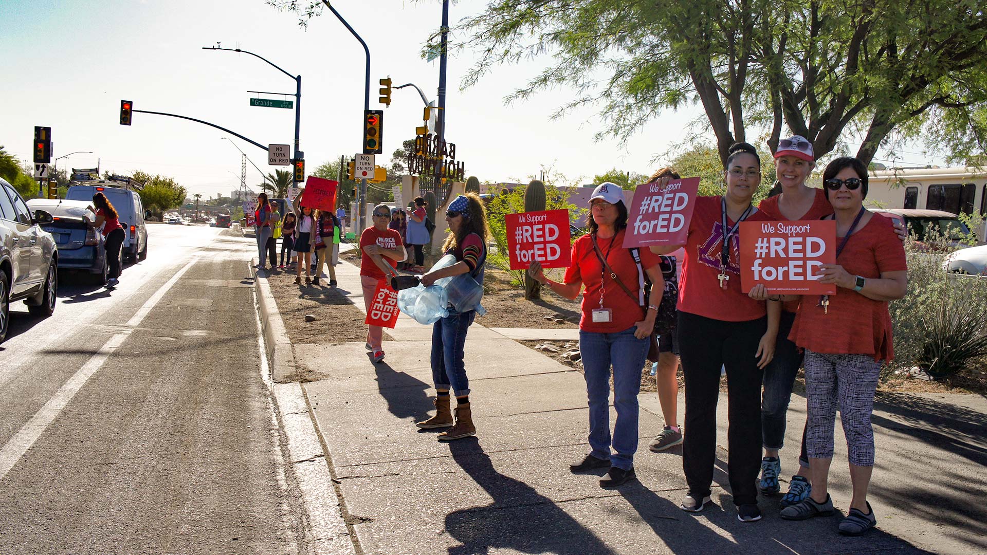 Educators protest before school on Tuesday, April 24, with #RedForEd signs in Tucson's Barrio Hollywood.