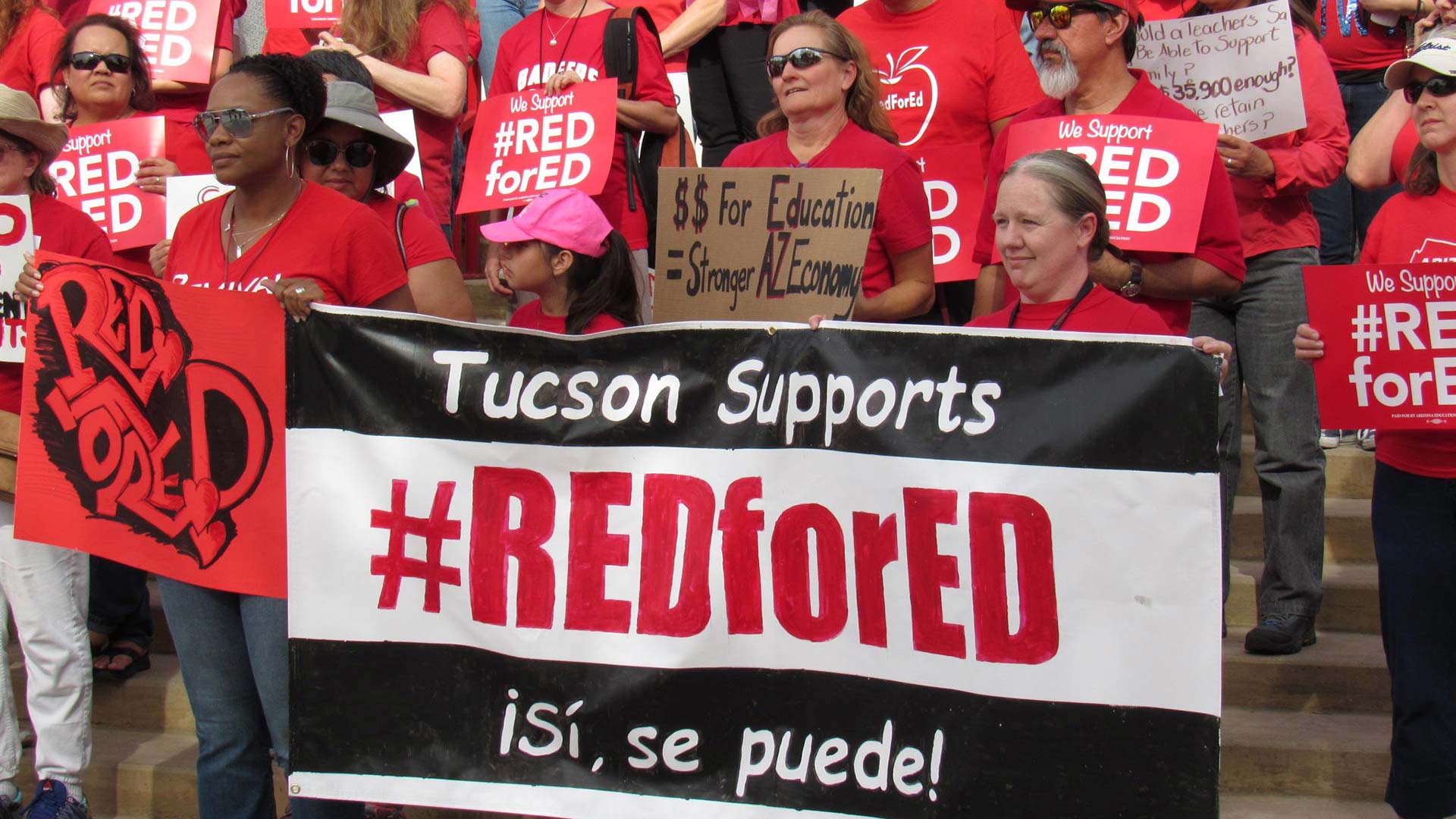 Teachers gather on the steps at Tucson High before walking downtown to protest for better pay.