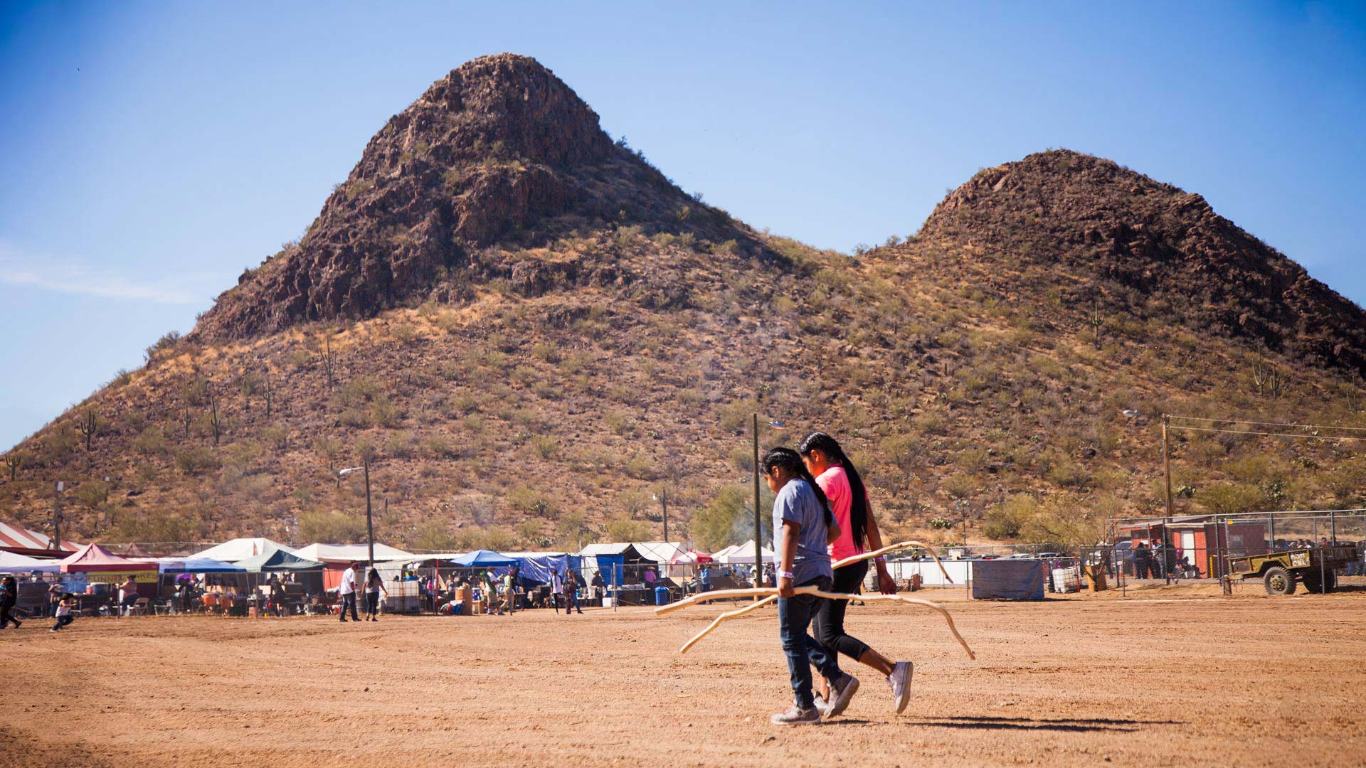 Young toka players walk across the Verna N. Enos Toka Field. 