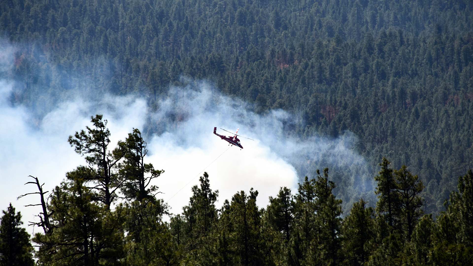 A helicopter helps battle the Tinder Fire, in north-central Arizona, April 30, 2018.