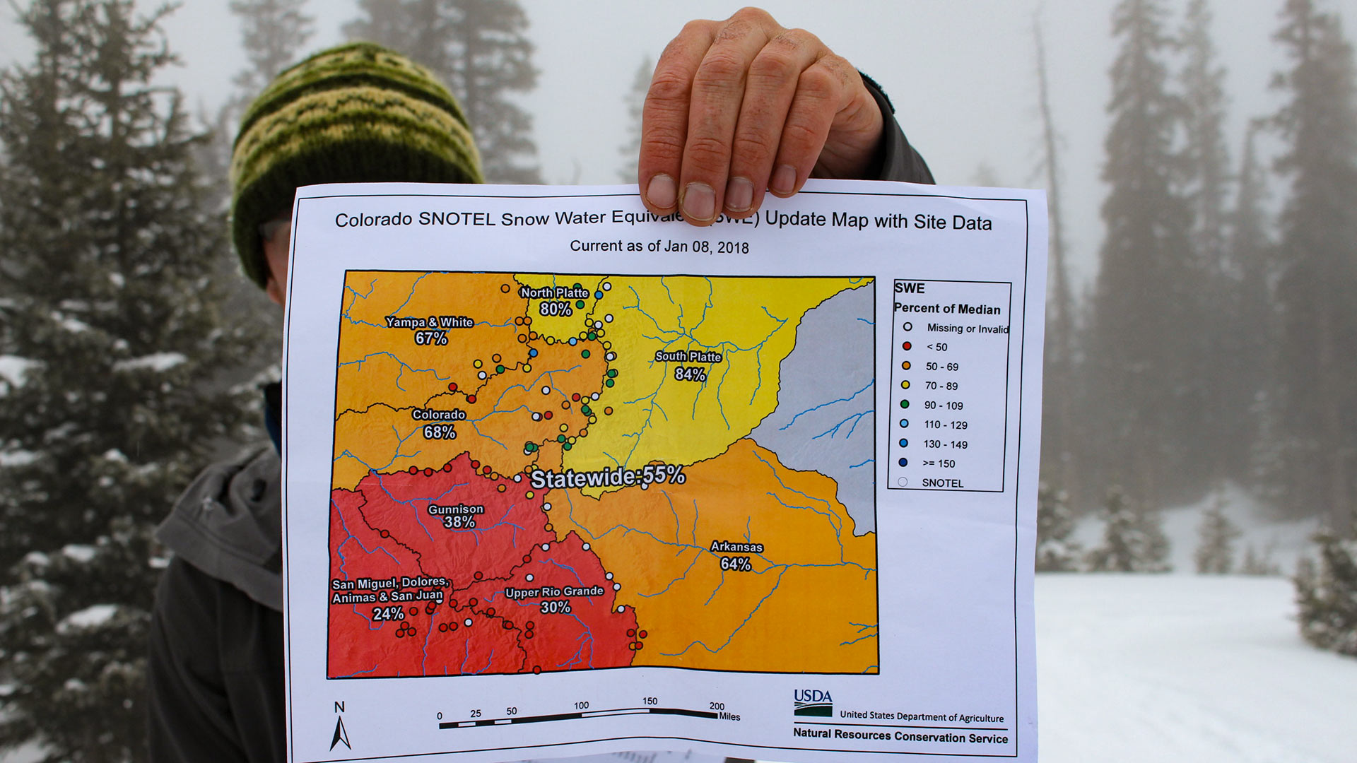 Hydrologist Karl Wetlaufer with the Natural Resources Conservation Service holds a map showing Colorado's low snowpack on Jan. 9, 2018. 
