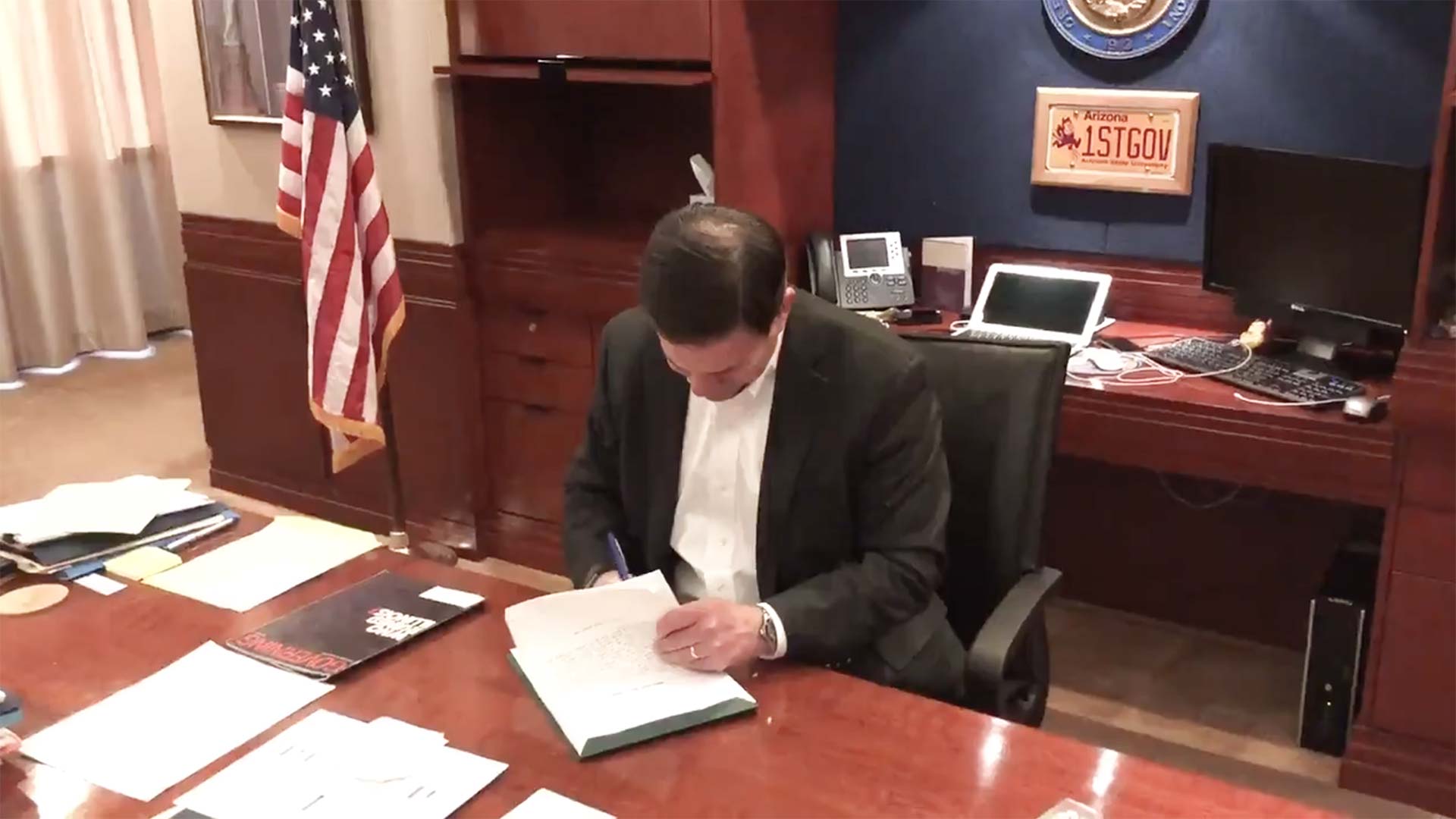 Arizona Gov. Doug Ducey signs a bill early in the morning of May 2, 2018, putting 19 percent teacher raises into the Arizona budget over the following three school years.