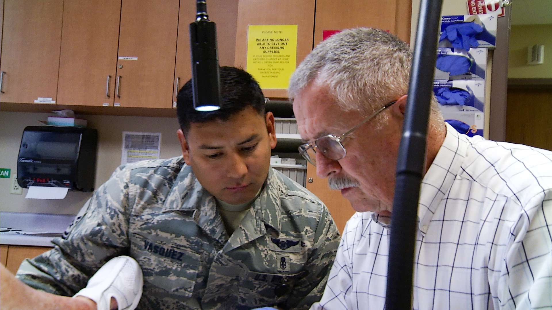 Master Sgt. Pablo Vasquez assists in treating a patient with retired vascular trauma surgeon Michael Lavor.