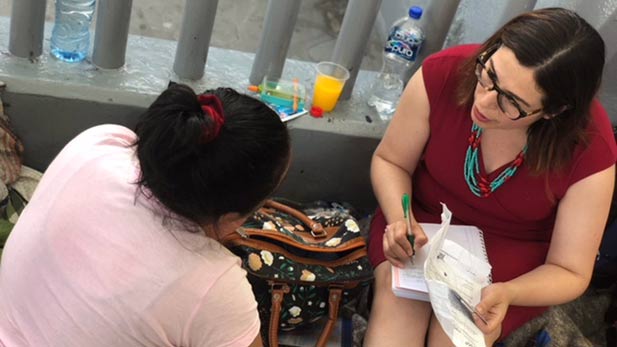 Immigration attorney Lucero Ortiz gives free legal advice in Nogales, Sonora, to a woman seeking asylum in the U.S., 2018.