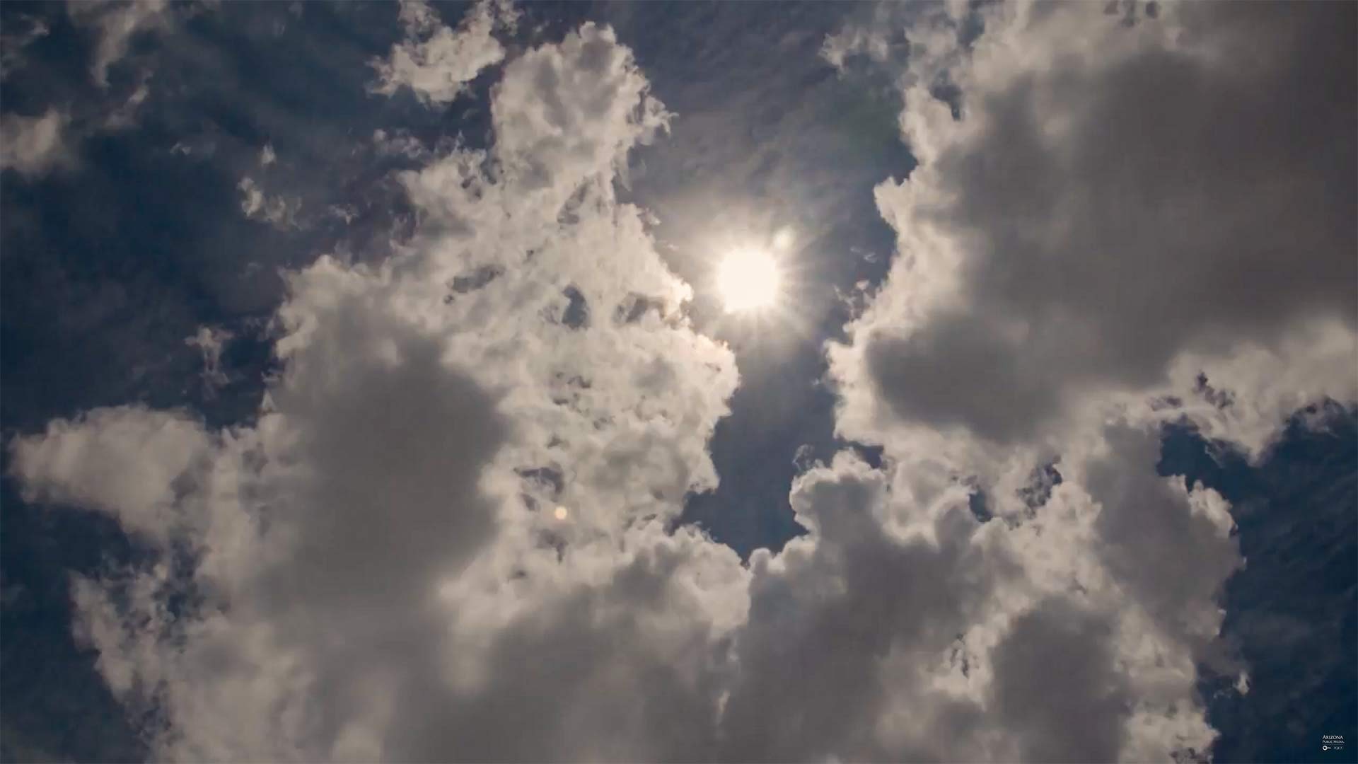 The sun peers through the clouds in Southern Arizona.