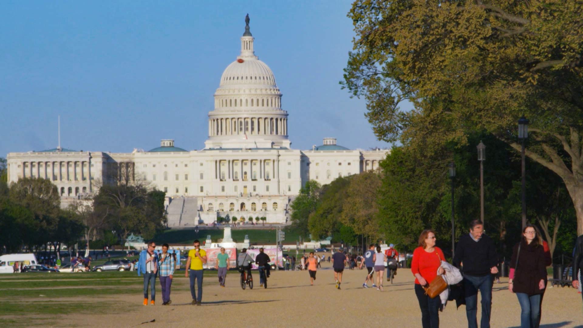 People walk along the Mall in front of the U.S. Capitol in Washington, D.C.