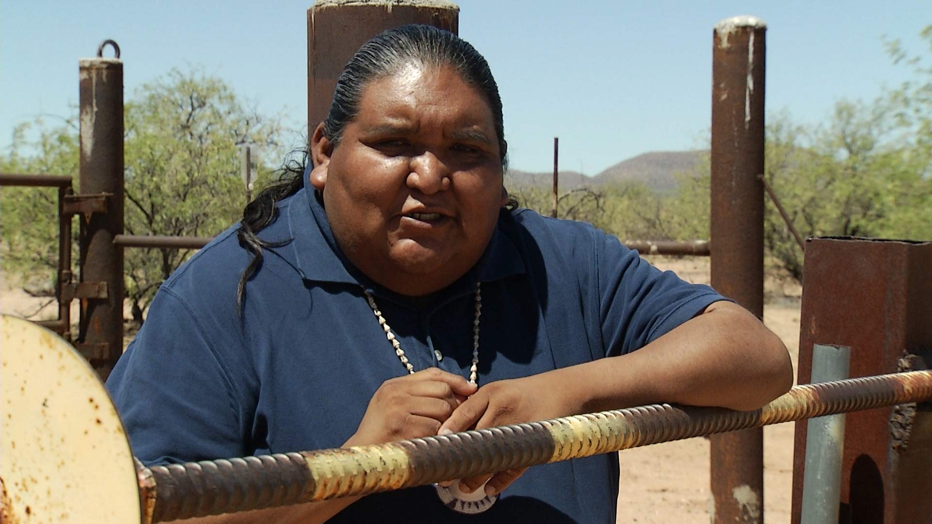 Tohono O'odham Vice Chairman Verlon Jose leans against a fence on the U.S.-Mexico border, which divides the Nation.