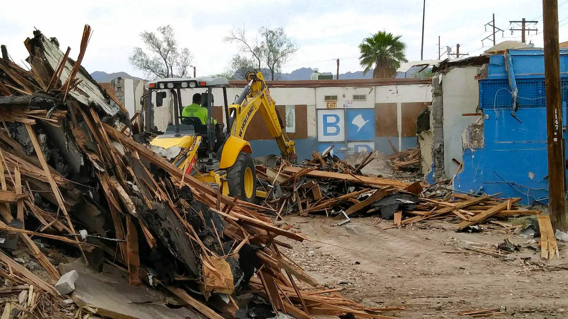 Workers tear down the Beau Brummel Social Club at North Main Avenue and Speedway Boulevard, June 13, 2018.