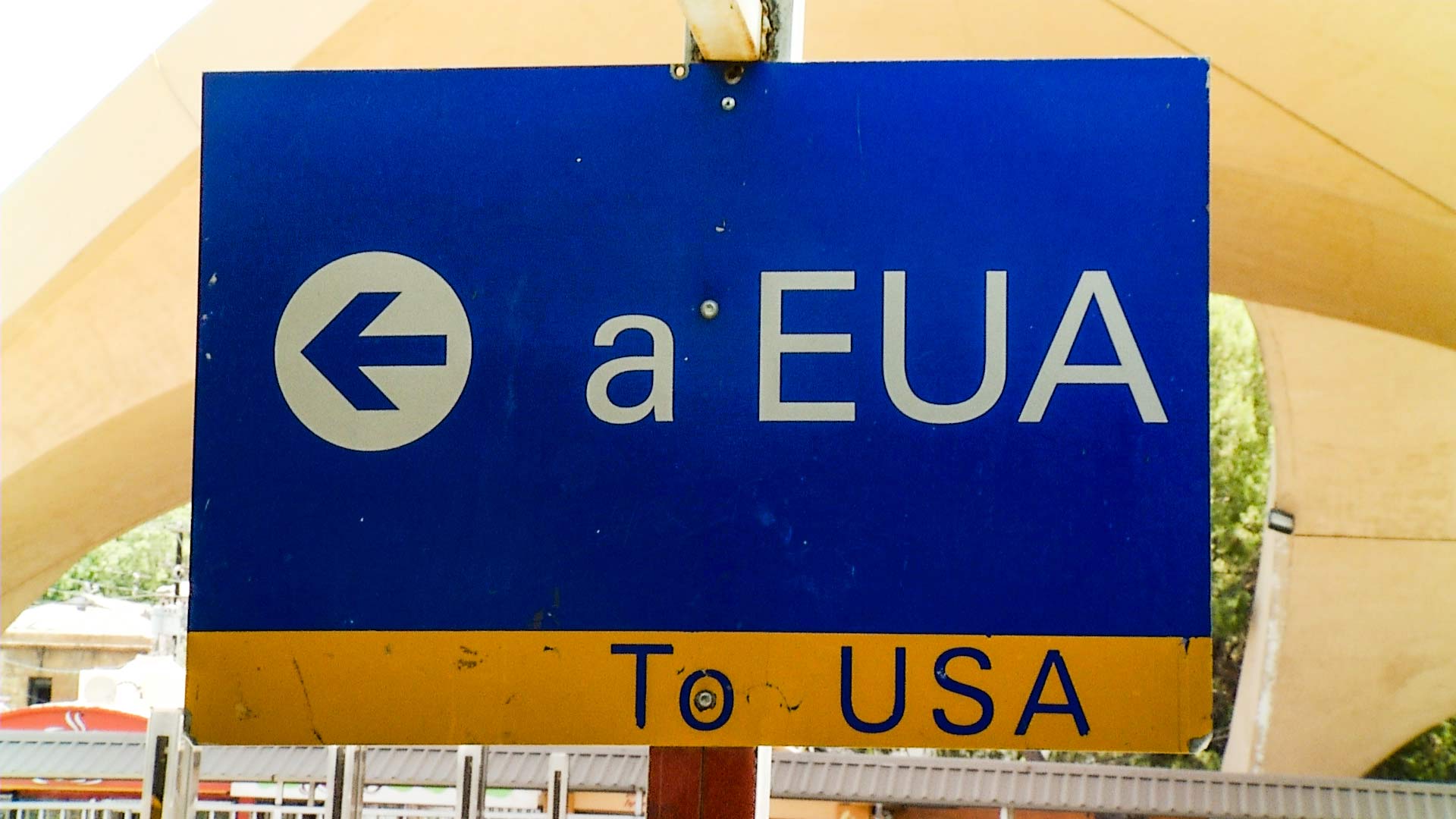 A sign pointing in the direction of the U.S. at a port of entry in Nogales, Mexico.