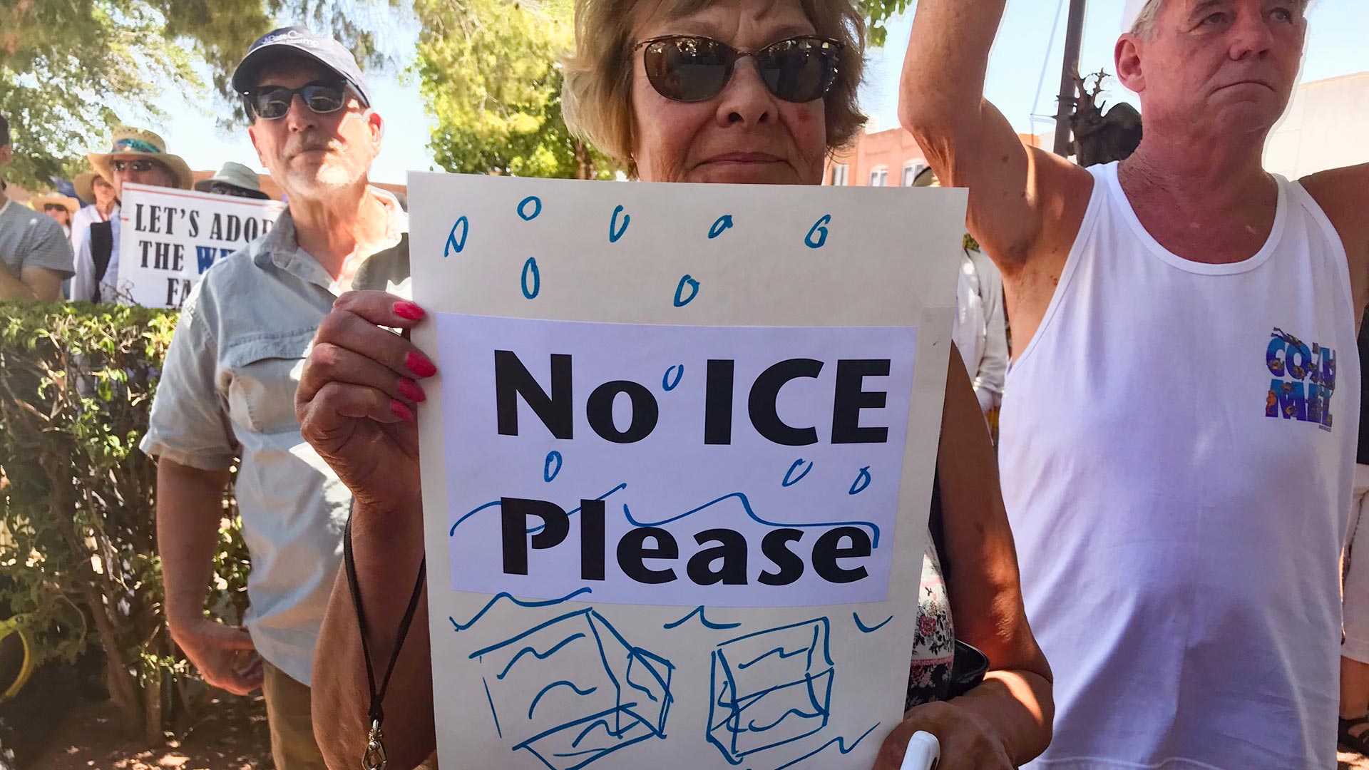 A protester holds a sign at a border demonstration in Nogales, Arizona. (June, 2018) 