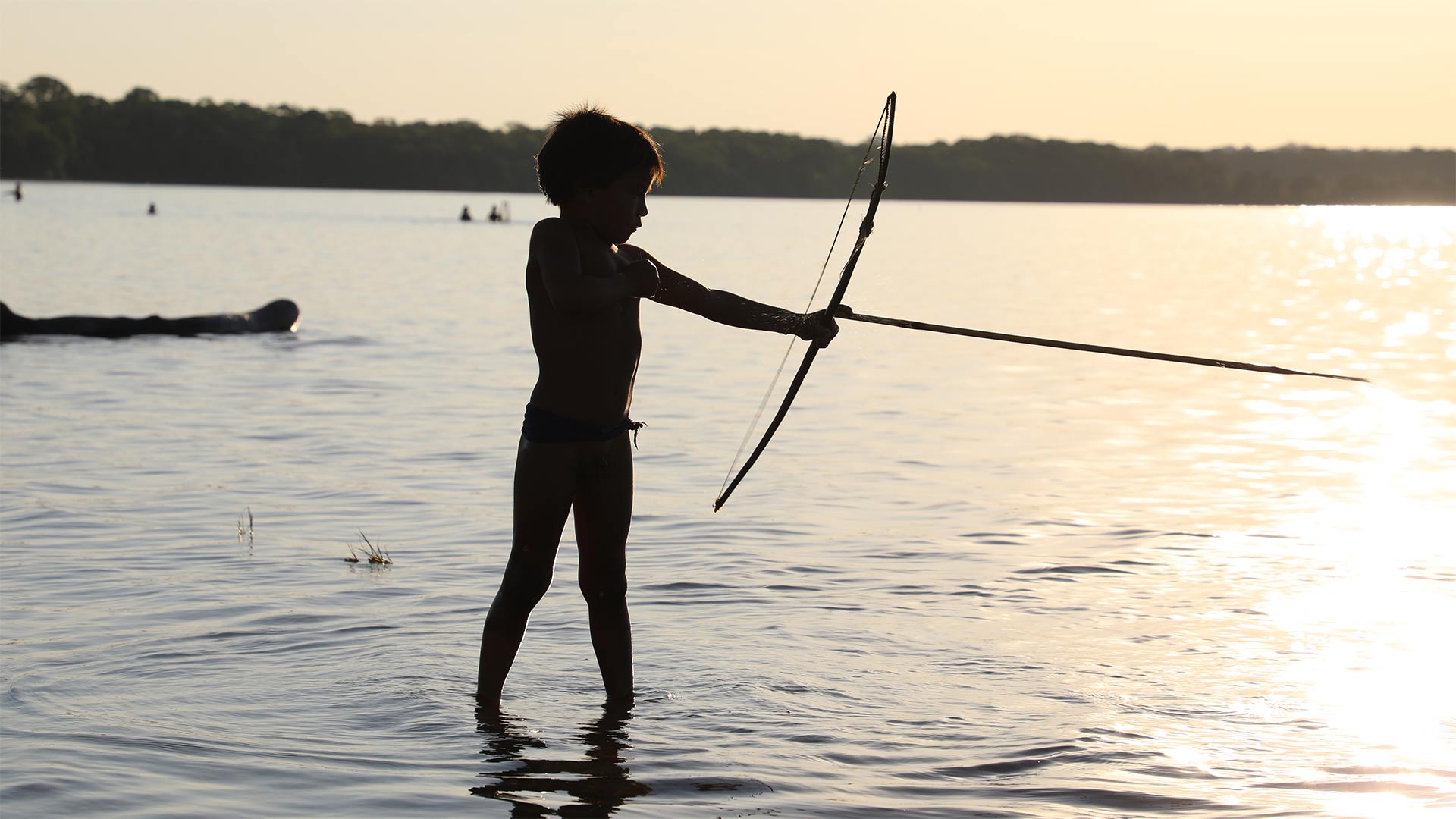 Child fishing with bow and arrow in Matto Grosso, Brazil.