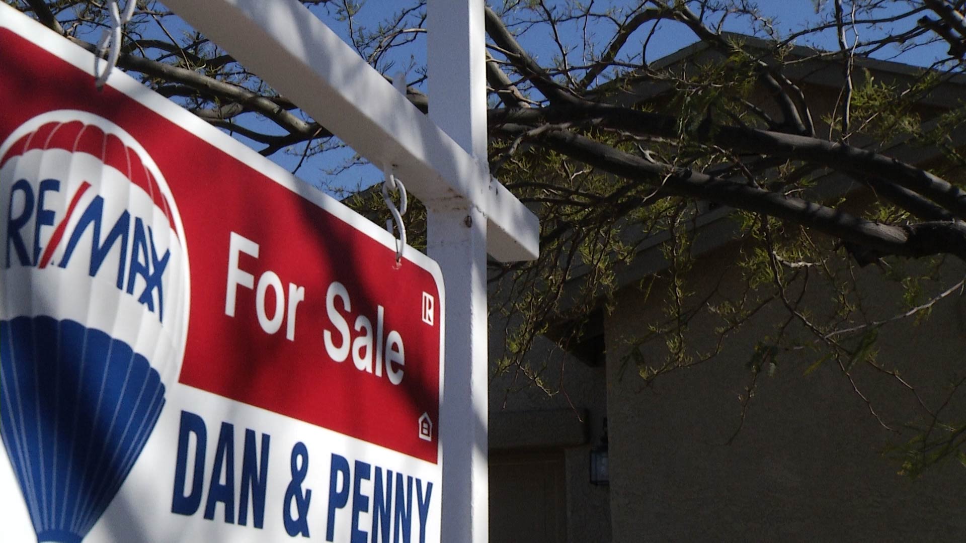 File image of a for sale sign outside a home in the Tucson metropolitan area. 