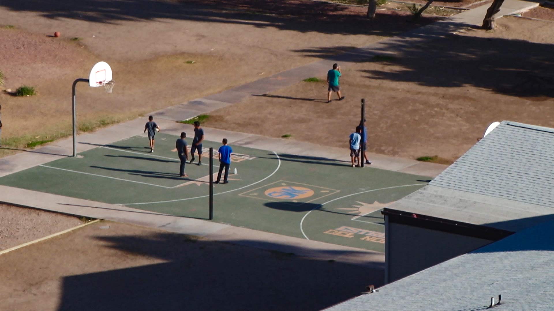 Kids play on a basketball court at the Southwest Key facility in Tucson, July 7, 2018