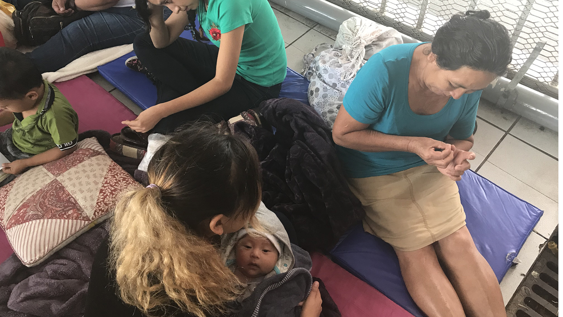 Women with children waiting to apply for asylum at the Nogales Port of Entry.  They are claiming domestic violence in their home countries. (July 5, 2018)