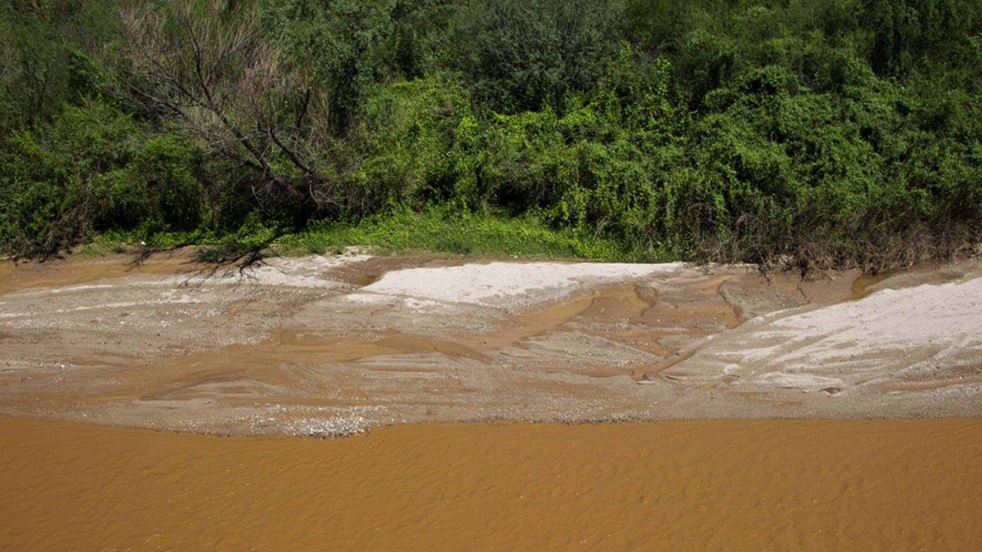 The Rio Sonora, Aug. 10, 2014, red from a chemical spill at a copper mine near Cananea, Mexico. The mine is owned by Grupo Mexico, the largest mining corporation in Mexico.