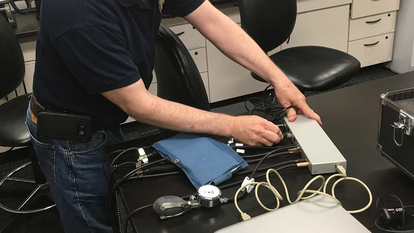 A contractor for the law enforcement in the Tucson area sets up polygraph equipment.