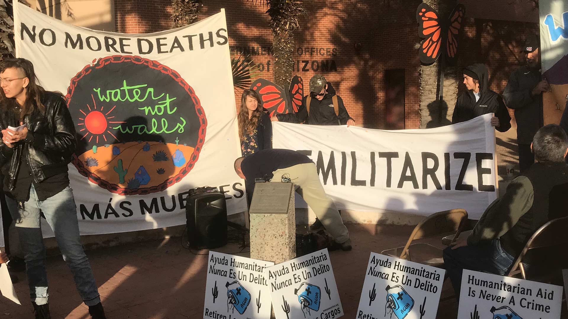 Signs held by No More Deaths supporters before the start of trial of four volunteers, Jan. 15, 2019.