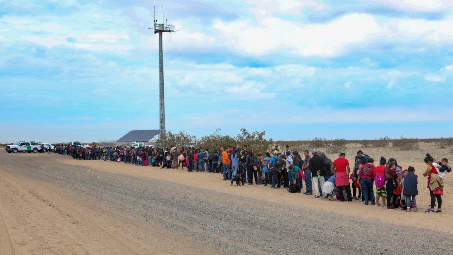 Migrants who crossed the border near Yuma in tunnels under the border fence stand in line waiting for Border Patrol agents to process them on Jan. 14, 2019.